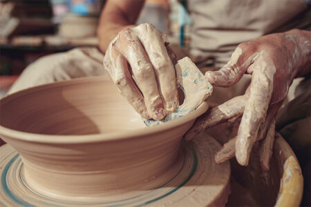 creating-a-jar-or-vase-of-white-clay-close-up-6YMVRJK-450x300